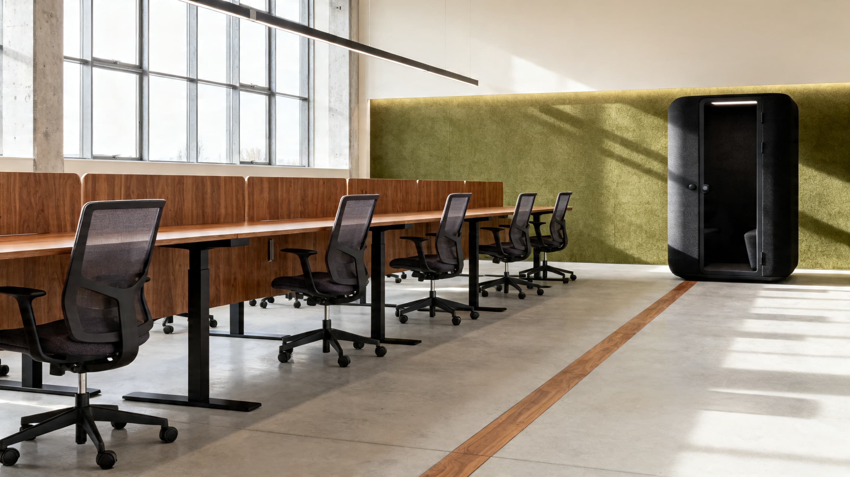 OBJEKT contract office furniture in a corporate workplace — sit-stand desks, task chairs and acoustic enclosure